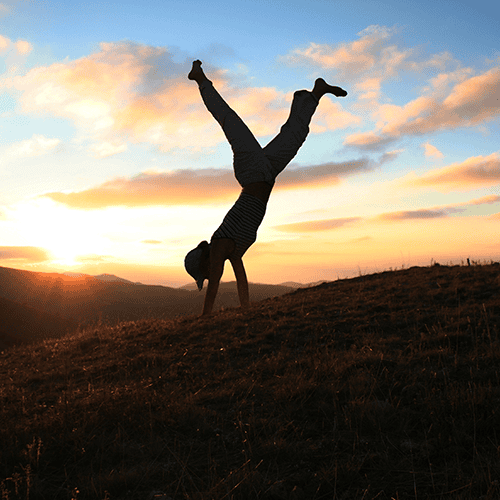 Child tumbling in field